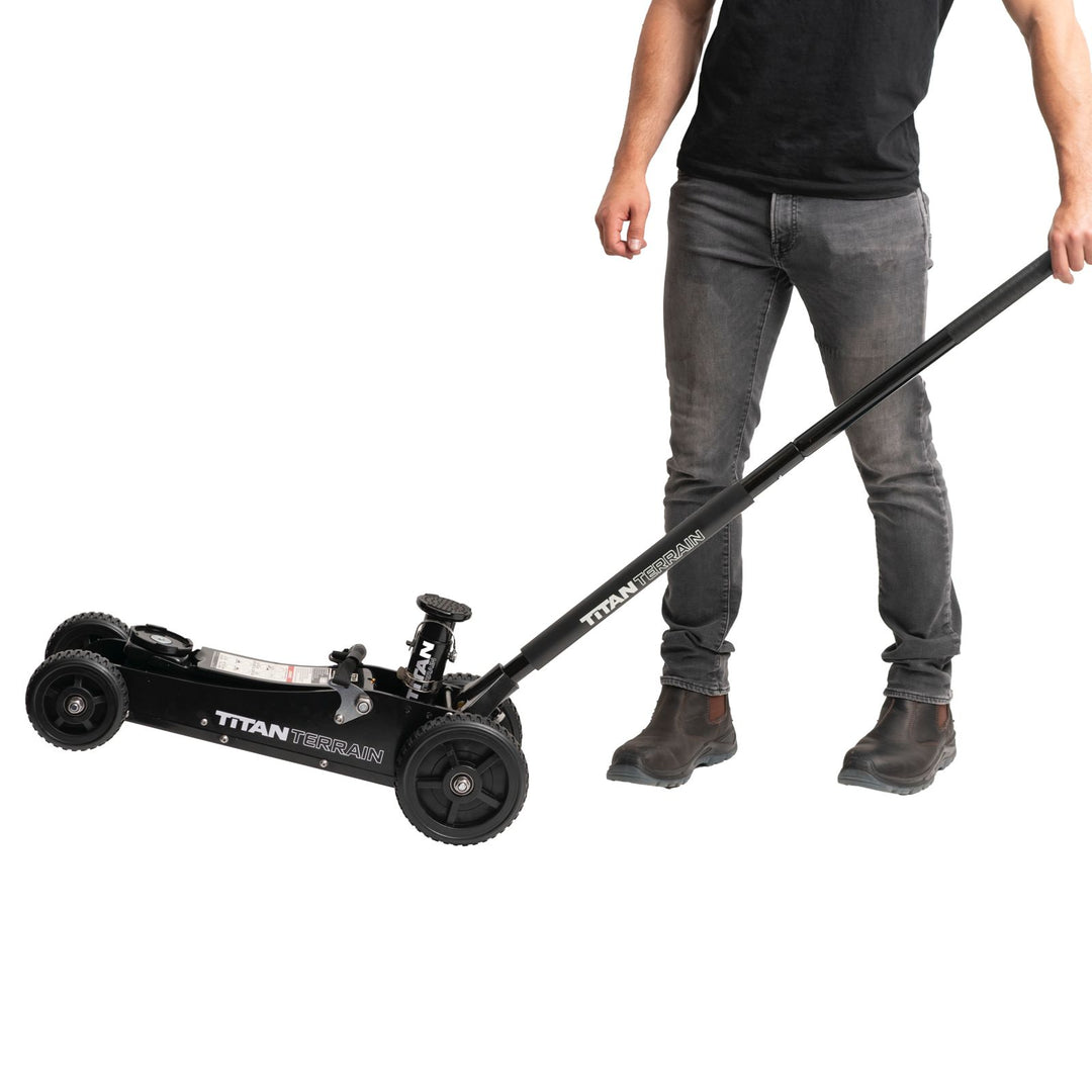 Man tilting titan terrain rugged floor jack on back wheels